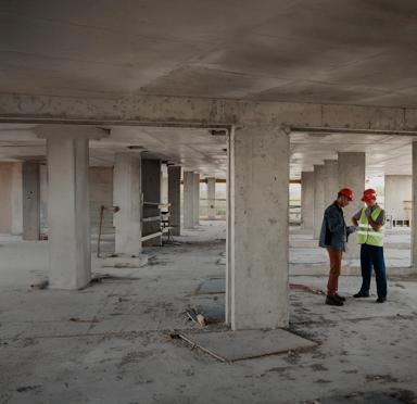 2 workers in uniform at a construction site