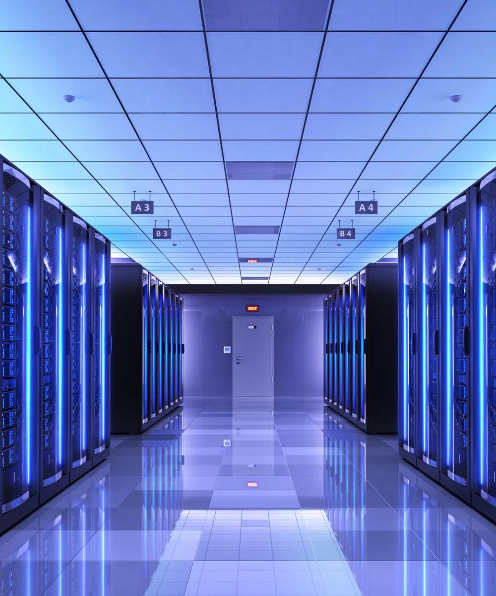 Hallway with glass and blue lights inside a data center