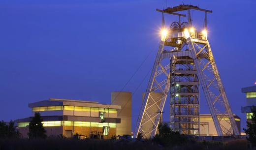 A Gold mine head gear and lift pulley station building in Gauteng South Africa, shot taken at dusk.