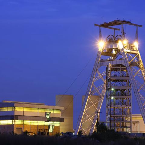 A Gold mine head gear and lift pulley station building in Gauteng South Africa, shot taken at dusk.