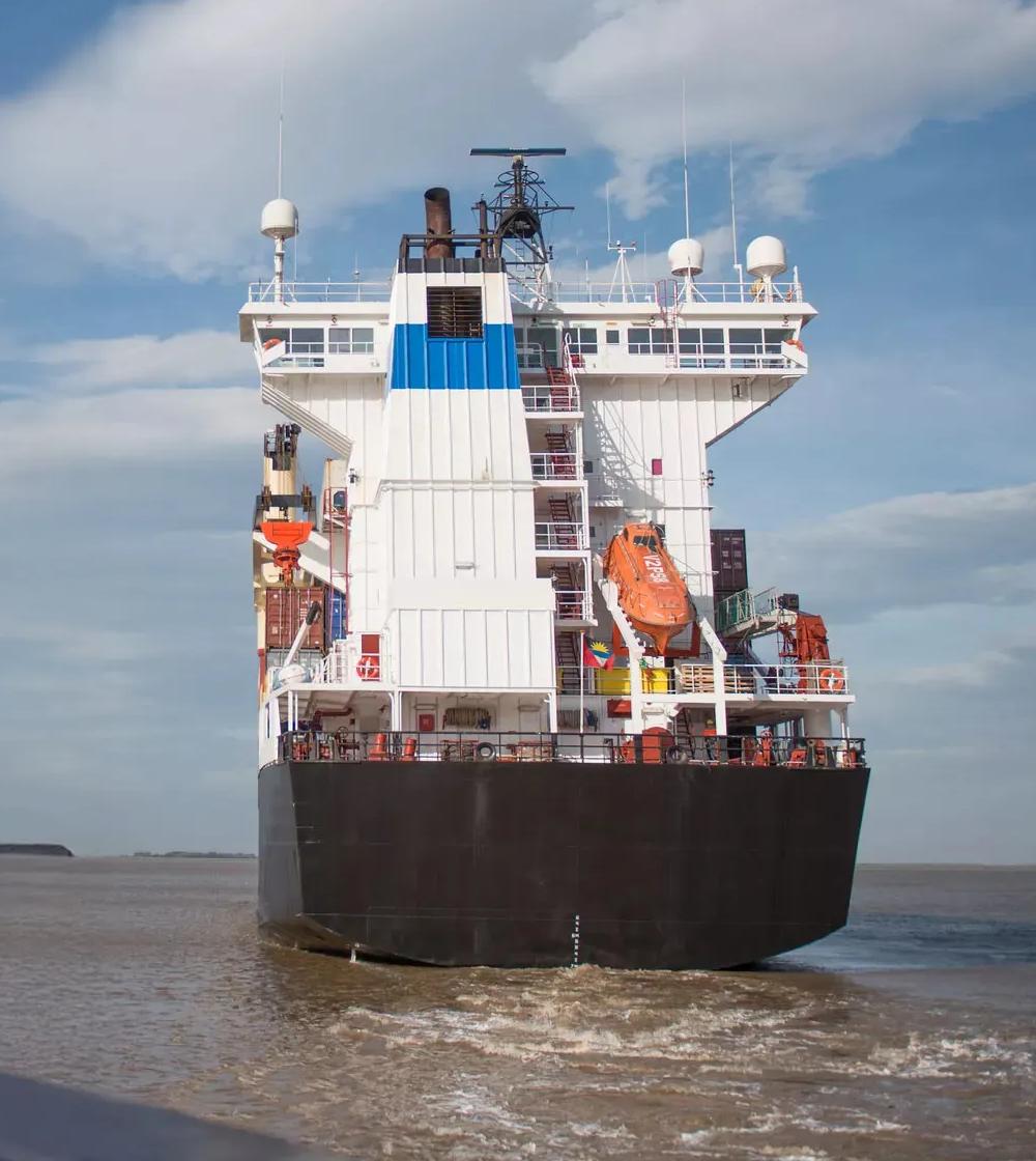View of the back of a cargo ship at sea.