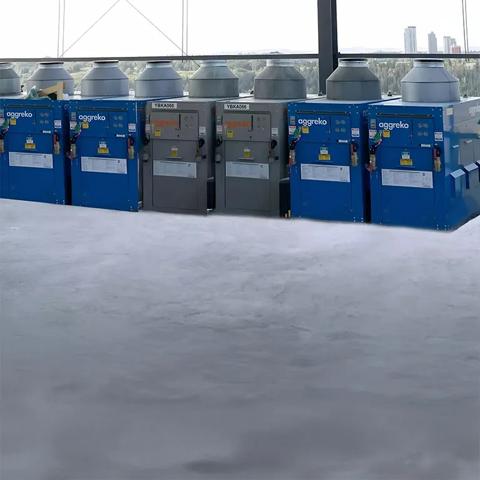 Blue and black Aggreko heaters sitting outdoors
