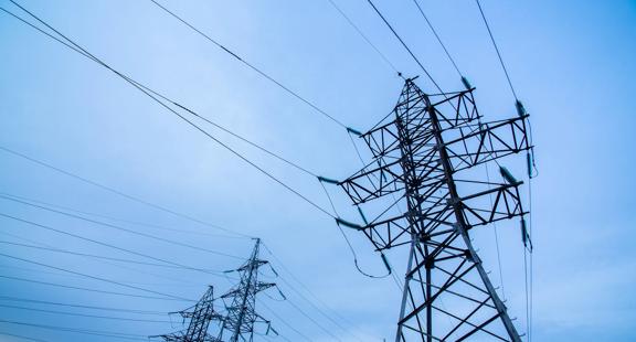Electricity pylons on blue sky background.