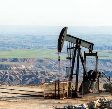 View of the pumpjack in the oil well of the oil field. The arrangement is commonly used for onshore wells producing little oil. Pumpjacks are common in oil-rich areas.