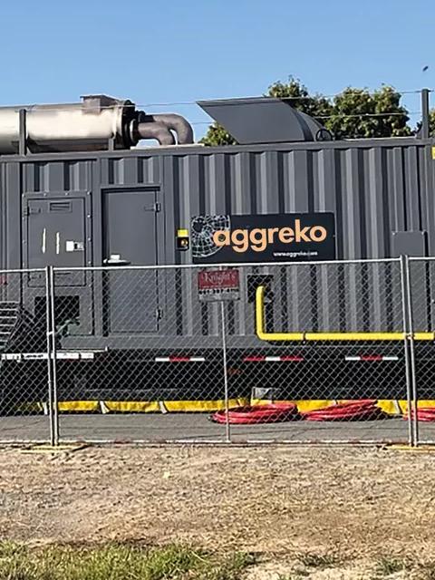 View of a temporary utility setup with generators and a transformer.