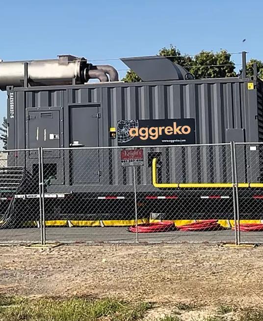 View of a temporary utility setup with generators and a transformer.