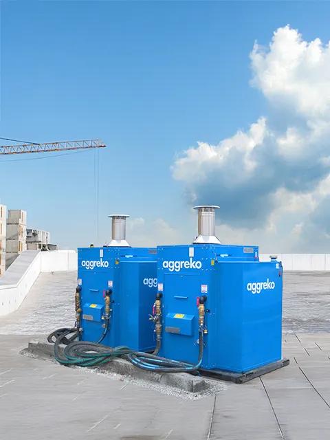 Shot of a pair of blue Aggreko heaters sitting outside.