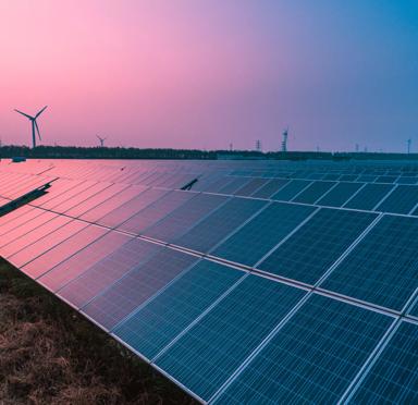 Solar panels with wind turbines on a sunny day,green clean energy concept