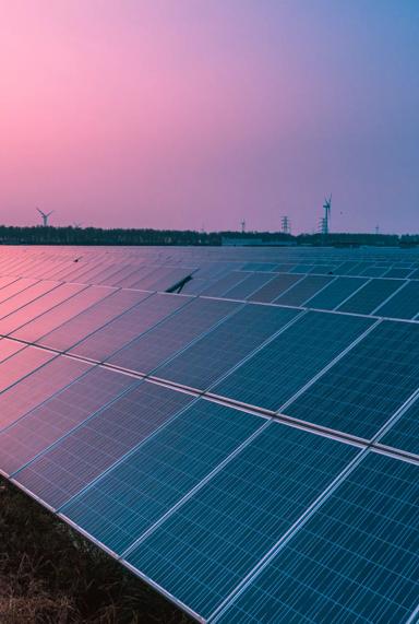 Solar panels with wind turbines on a sunny day,green clean energy concept