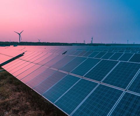 Solar panels with wind turbines on a sunny day,green clean energy concept