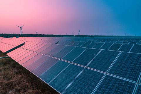 Solar panels with wind turbines on a sunny day,green clean energy concept