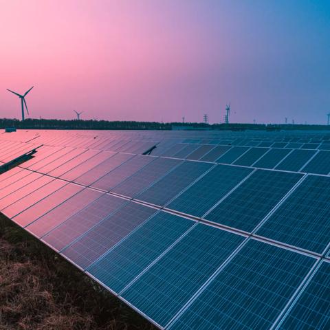 Solar panels with wind turbines on a sunny day,green clean energy concept