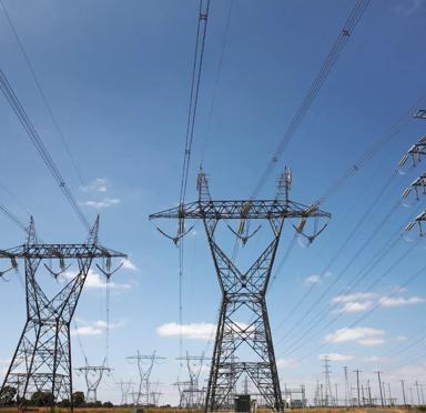 Stock Image- Very wide angle view of high voltage power pylons.