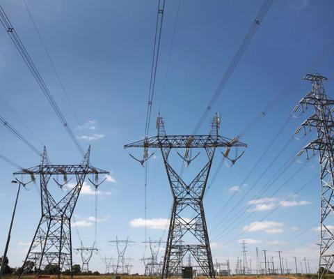 Stock Image- Very wide angle view of high voltage power pylons.