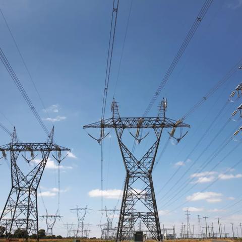 Stock Image- Very wide angle view of high voltage power pylons.