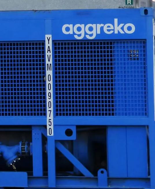 Industrial equipment and blue Aggreko units at a work site.