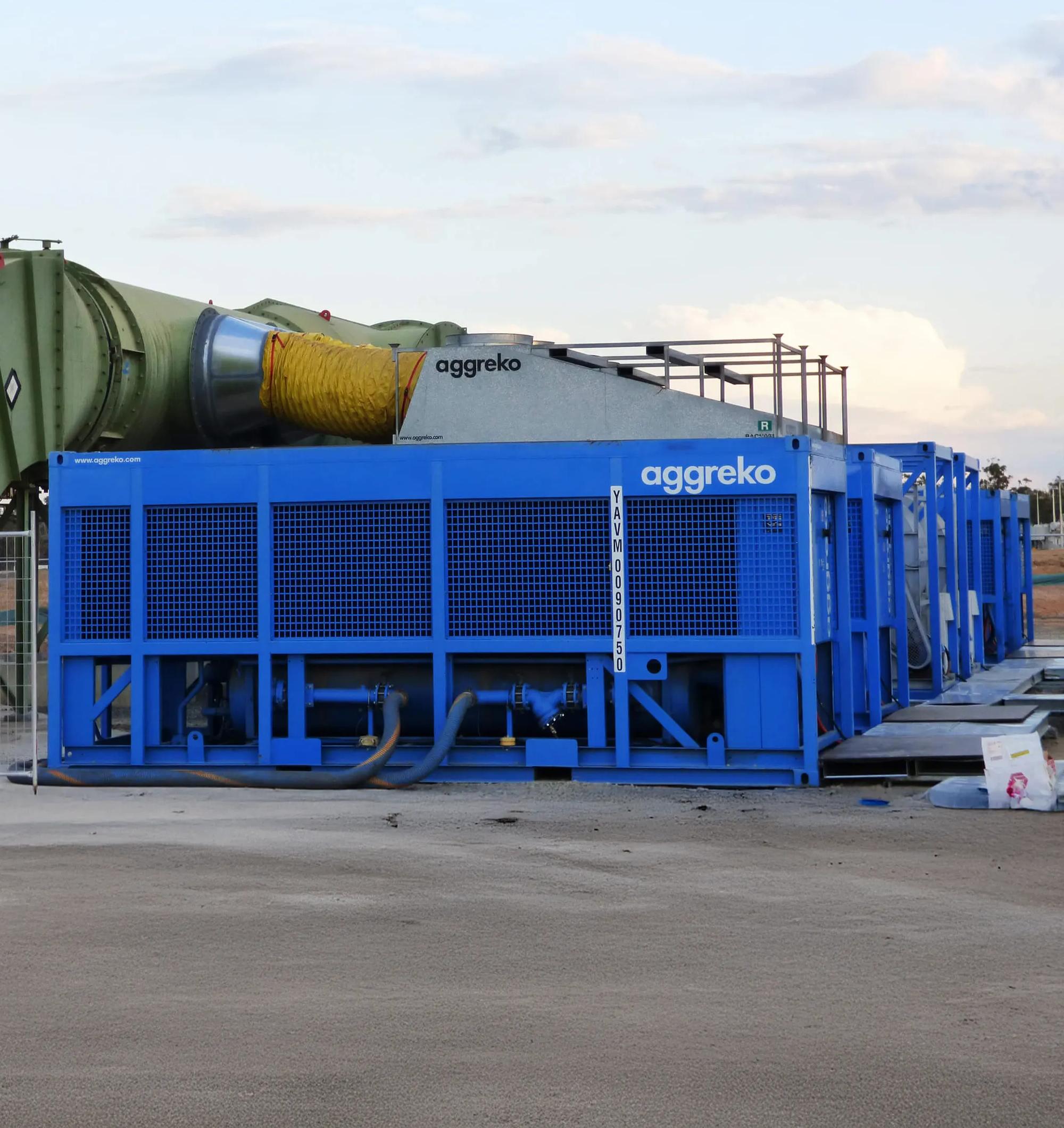 A close-up of a large, blue industrial Aggreko machine with a grated front panel.