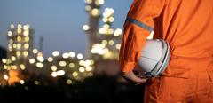 Engineer and blur refinery oil background.