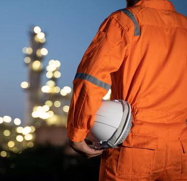 Engineer and blur refinery oil background.