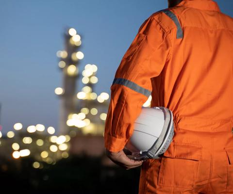Engineer and blur refinery oil background.
