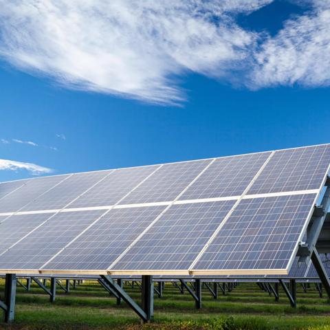 Solar panels and blue sky in the background.See also: