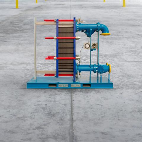 An industrial heat exchanger unit with exposed black plates, red tightening bars, mounted on a blue skid frame with connected blue piping, and yellow flanges.