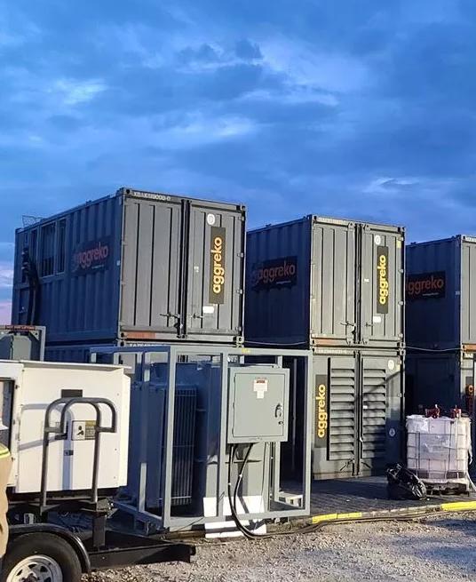 Aggreko equipment on a construction site with a technician