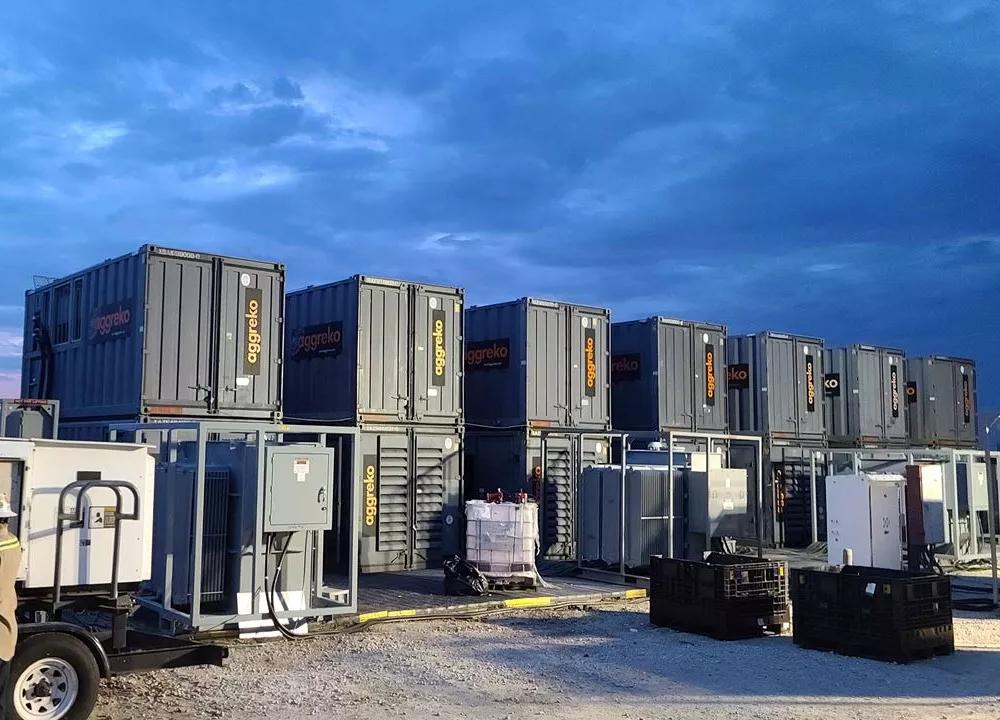 Aggreko equipment on a construction site with a technician