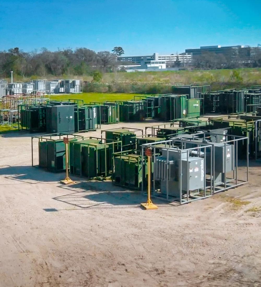 Grey Aggreko transformers with other equipment at a worksite