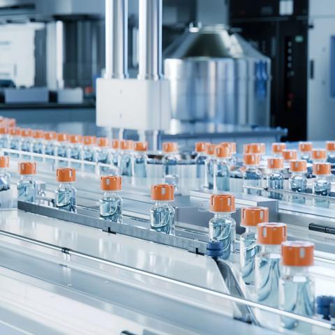 Advanced Bright Modern Pharmaceutical Factory. Medical Ampoule Production Line. Rows of Glass Vials with Orange Caps on Conveyor Belt. Vaccine Production Facility. Medication Manufacturing Process.