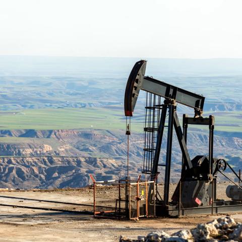 View of the pumpjack in the oil well of the oil field. The arrangement is commonly used for onshore wells producing little oil. Pumpjacks are common in oil-rich areas.