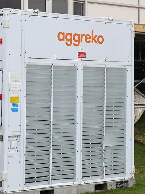 Équipement de refroidissement Aggreko raccordé à des gaines d’air flexibles à l’extérieur d’un bâtiment.