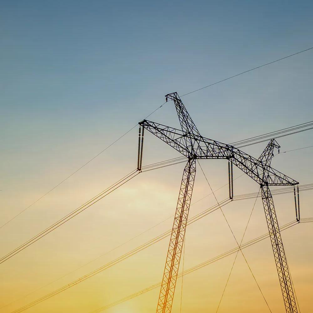 View of a transmission tower with the Sun in the background