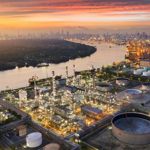 Aerial view oil and gas industrial, Refinery factory oil storage tank and pipeline steel at sunset