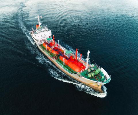 Aerial view Ship tanker Liquefied Petroleum Gas (LPG) on the sea with beautiful wave pattern delivery  from refinery for transportation.