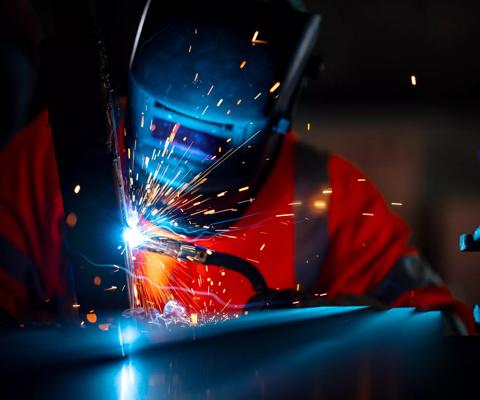 Structural Welding, Welding Engineering. African American welders use carbon arc welding torches for spot welding of a construction beam in the construction industry.