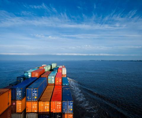 Container ship on Elbe river heading towards North Sea (sunrise)