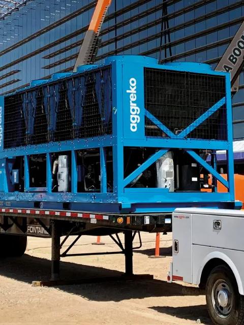 Aggreko industrial equipment being installed at a construction site.