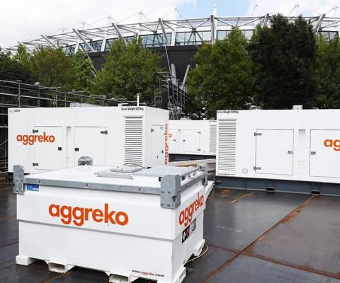 Aggreko generators and fuel tanks in front of a stadium