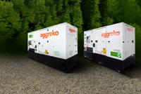 Two white and gray containerized industrial Aggreko units sit on flat, brown terrain with a green background.