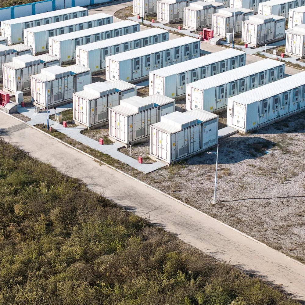 Aerial view of multiple rows of white industrial units outside.