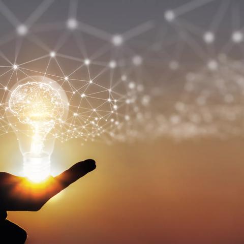 Hand of businessman holding illuminated light bulb, New ideas, innovation and inspiration concepts.