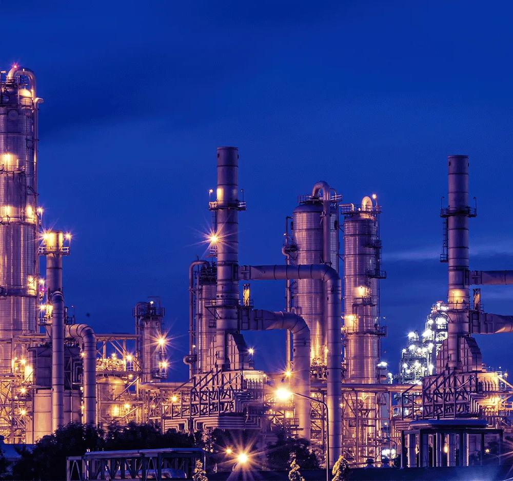 View of a petrochemical refinery plant at night.