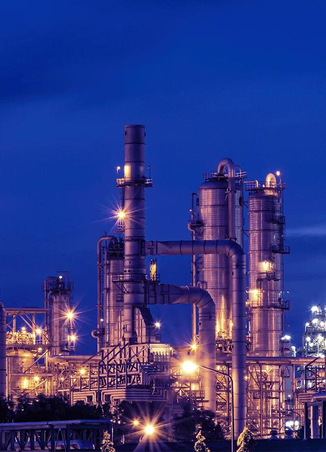View of a petrochemical refinery plant at night.