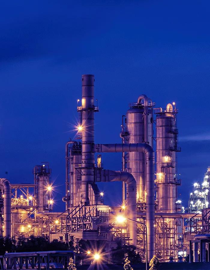 View of a petrochemical refinery plant at night. 
