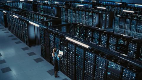 3D Computer Graphics: Data Center Female Chief Technology Officer Using Laptop Standing In Warehouse, Activates Servers, Information Digitalization Starts. SAAS, Cloud Computing, Online Service