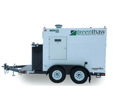 A close-up view of a white, trailer-mounted industrial generator unit, featuring a door, large black wheels, a tow hitch, and a black fuel tank or storage compartment on the left side.