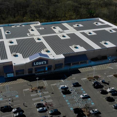 An aerial panoramic view of a large, single-story commercial or retail building.  