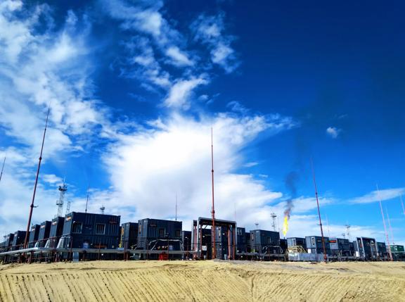 Flare gas project, gas containers with blue sky and flare in background