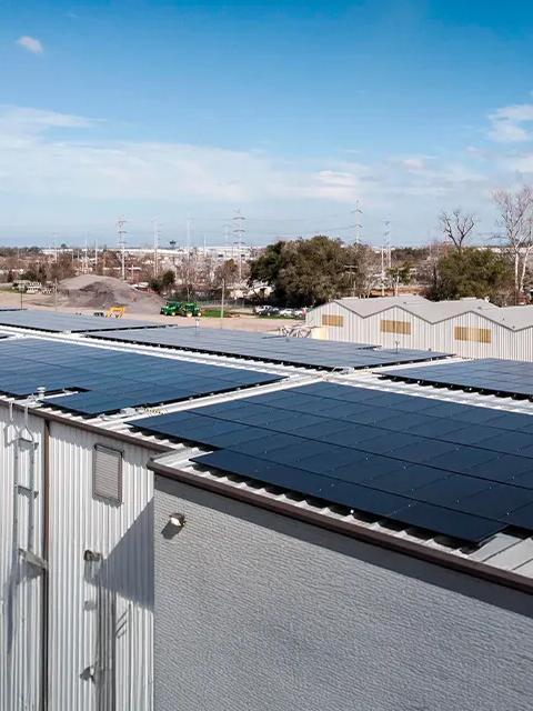 Aerial view of several service centers with solar panels on the roofs.